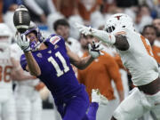 Washington wide receiver Jalen McMillan (11) fails to make a catch in front of Texas defensive back Ryan Watts (6) during the first half of the Alamo Bowl NCAA college football game in San Antonio, Thursday, Dec. 29, 2022.