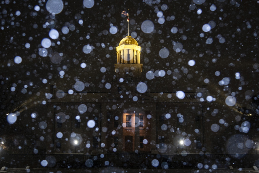 Snow falls during a blizzard warning, Wednesday, Dec. 21, 2022, at the Old Capitol Building in Iowa City, Iowa.