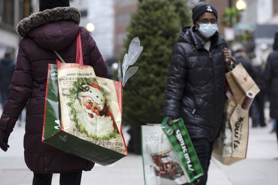 People carry shopping bags on Saturday, Dec. 10, 2022 at Downtown Crossing in Boston.