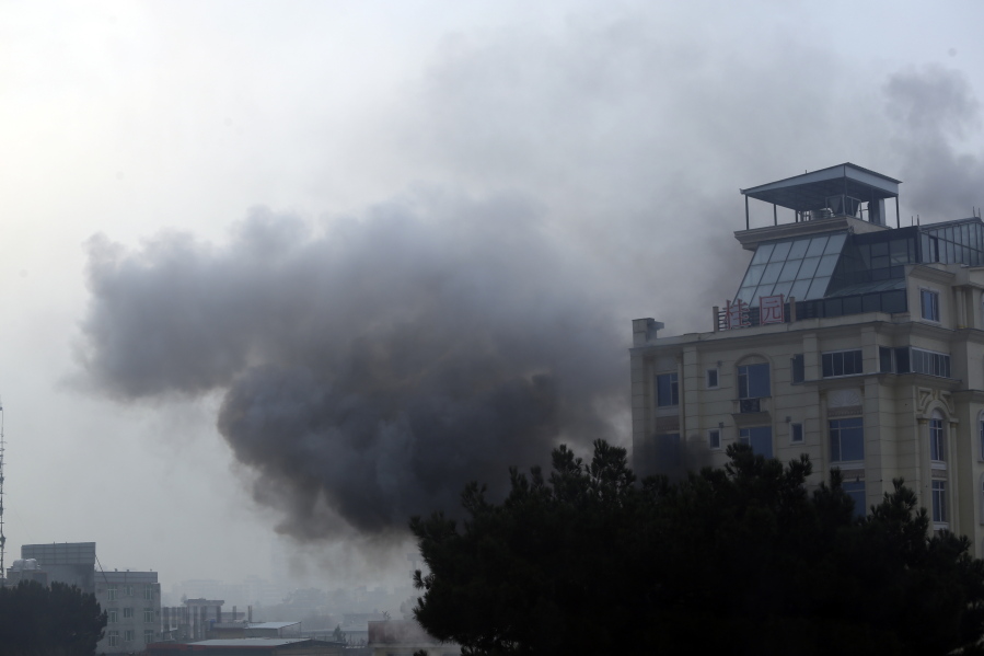 Smoke rises from a hotel building after an explosions and gunfire in the city of Kabul, Afghanistan, Monday, Dec. 12, 2022. A Taliban official says that a hotel building has come under a complex attack in the Afghan capital Kabul.