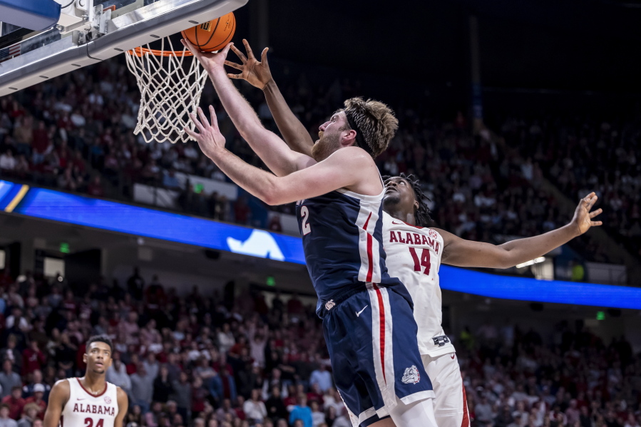 Gonzaga forward Drew Timme (2) gets past Alabama center Charles Bediako (14) for a basket during the second half of an NCAA college basketball game, Saturday, Dec. 17, 2022, in Birmingham, Ala.