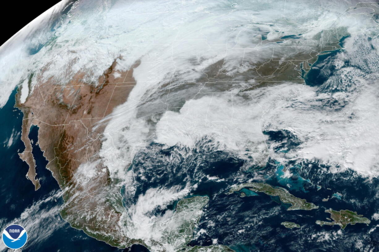 This satellite image made available by NOAA shows cloud cover over North America on Wednesday, Dec. 21, 2022 at 1:31 p.m. An arctic blast is bringing extreme cold, heavy snow and intense wind across much of the U.S. this week -- just in time for the holidays.