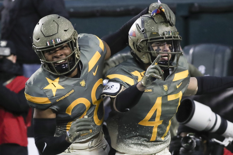 Army defensive back Noah Short (47) celebrates blocking a punt return by Navy punter Riley Riethman for a touchdown in the second quarter of an NCAA college football game in Philadelphia, Saturday, Dec. 10, 2022. At left is fellow defensive back Donavon Platt.