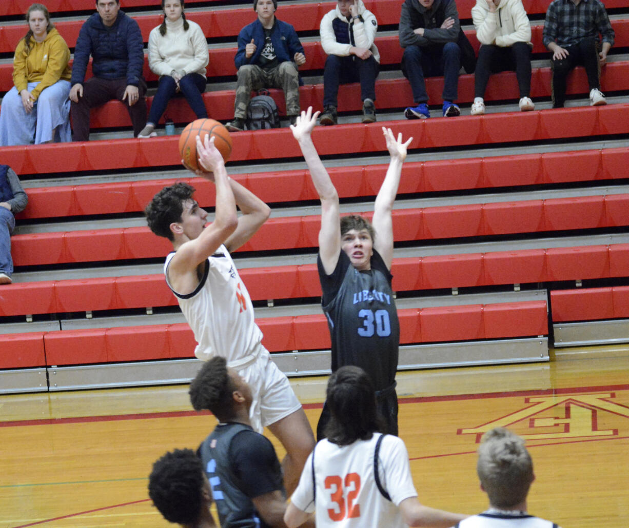 Battle Ground's Tait Spencer shoots the ball over Liberty's Lucas Whitbey (30) during the Tigers' 88-68 win at the Fort Vancouver Holiday Classic on Wednesday, Dec. 28, 2022.