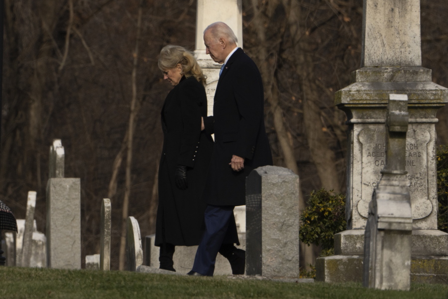 President Joe Biden and first lady Jill Biden walk between tombstones to attend Mass at St. Joseph on the Brandywine Catholic Church in Wilmington, Del., on Sunday, Dec. 18, 2022. Sunday marks the 50th anniversary of the car crash that killed Biden's first wife Neilia Hunter Biden and 13-month-old daughter Naomi.