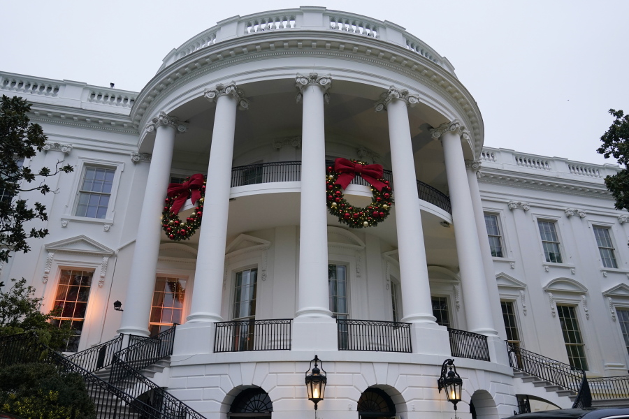 FILE - Wreaths hang on the Truman Balcony of the White House in Washington, Nov. 27, 2022. President Joe Biden celebrated a quiet Christmas with his family at the White House over a record-setting cold and windy weekend in the nation's capitol.