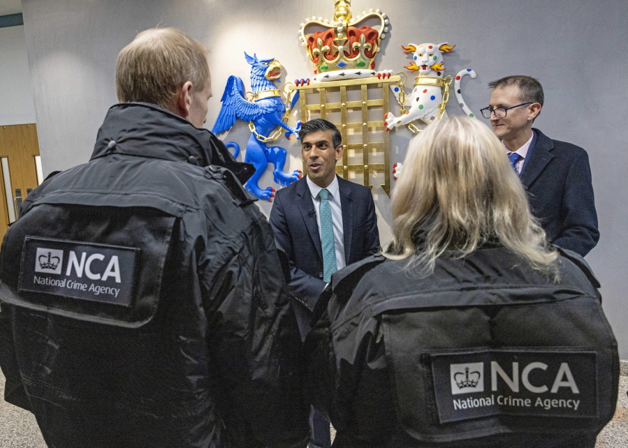 Britain's Prime Minister Rishi Sunak meets officers during his visit to the National Crime Agency headquarters in London, Tuesday, Dec. 13, 2022.