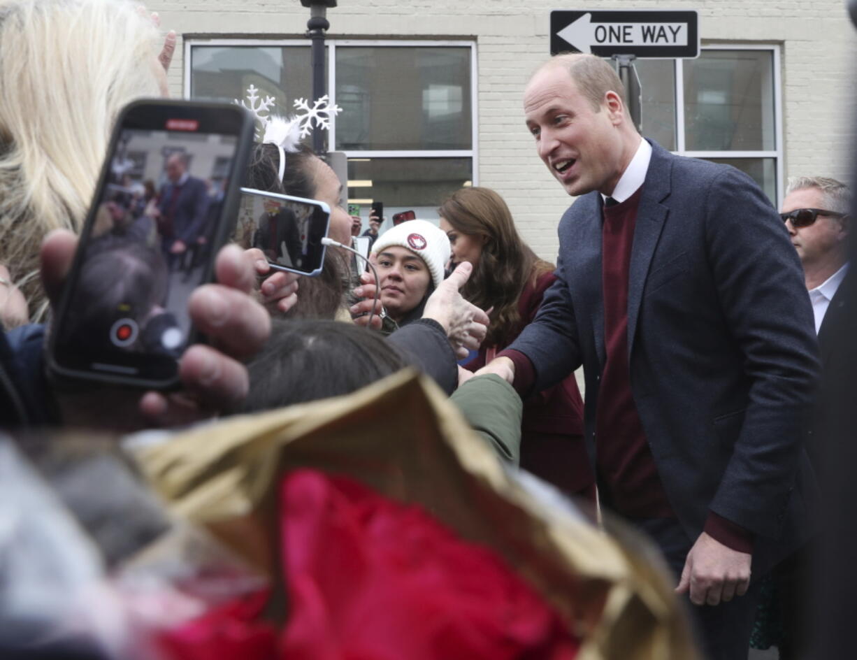 Britain's Prince William greets people in the crowd after a visit to Roca on Thursday, Dec. 1, 2022, in Chelsea, Ma.