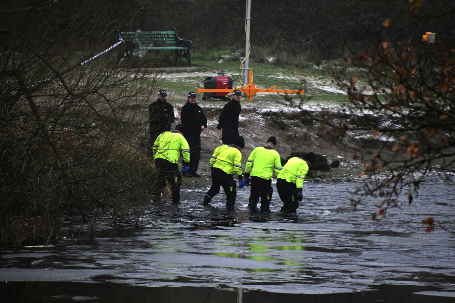 Police search teams at the scene after children fell through ice,in Babbs Mill Park in Kingshurst, Solihull, England, Monday, Dec. 12, 2022. Three young boys who fell through ice covering a lake in central England have died and a fourth remains hospitalized as weather forecasters issued severe weather warnings for large parts of the United Kingdom. Rescuers pulled the boys, aged 8, 10 and 11, from the icy waters Sunday afternoon and rushed them to the hospital in the West Midlands, about 100 miles (160 kilometers) north of London. But they could not be revived after suffering cardiac arrest.