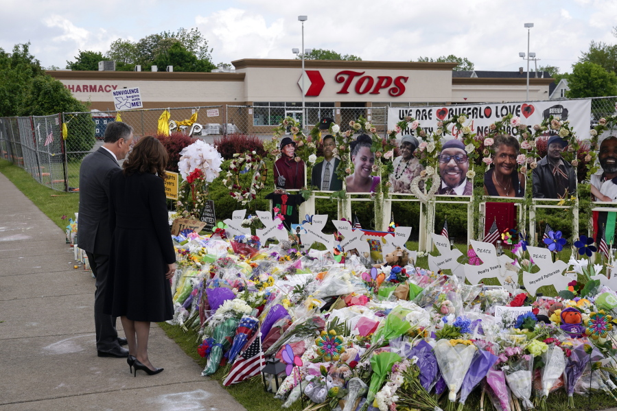 FILE - Vice President Kamala Harris and her husband Doug Emhoff visit a memorial near the site of the Buffalo supermarket shooting after attending a memorial service for Ruth Whitfield, one of the victims of the shooting, on May 28, 2022, in Buffalo, N.Y. Payton Gendron, the white gunman who pleaded guilty to state charges in the massacre of 10 Black people at the Buffalo supermarket, would be willing plead guilty to federal charges if spared the death penalty, his lawyer said in court Friday, Dec. 9.