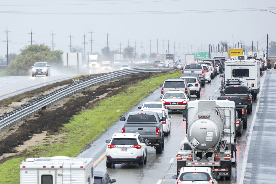 Cars are stopped in the northbound lanes of Highway 101 after flooding closed the highway near Chualar, Calif., Tuesday, Dec. 27, 2022.