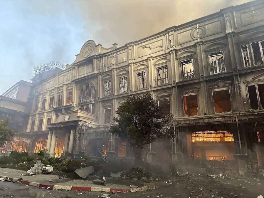 In this photo provided by Cambodia's Fresh News, a building burns near a Cambodia-Thai international border gate in Poipet, west of Phnom Penh, Cambodia, Wednesday, Dec. 28, 2022. A fire burning through the Grand Diamond City Casino and Hotel has killed multiple people and injured dozens of others, police said Thursday, and neighboring Thailand sent firetrucks to help fight the blaze in a bustling border region.
