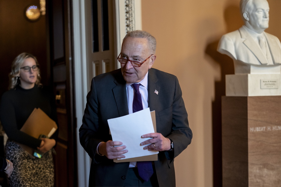 Senate Majority Leader Chuck Schumer, D-N.Y., emerges from a closed-door meeting with fellow Democrats before speaking with reporters, at the Capitol in Washington, Tuesday, Dec. 13, 2022. (AP Photo/J.