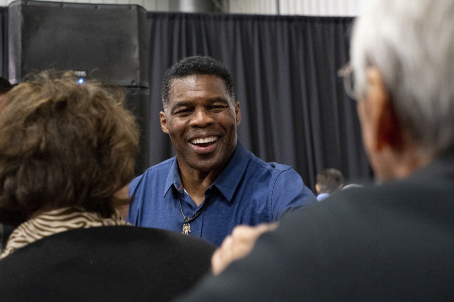 Republican candidate for U.S. Senate Herschel Walker greets supporters during a campaign stop at the Governors Gun Club in Kennesaw, Ga., on Monday, Dec. 5, 2022.