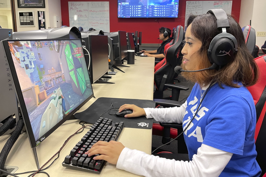 Lethrese Rosete, a 20-year-old DePaul sophomore who is majoring in UX design to combine her creativity and coding skills, plays an online game at the university's Esports Gaming Center Thursday, Sept. 22, 2022, in Chicago. A growing effort to channel students' enthusiasm for esports toward preparing them for jobs in science, technology, engineering and math could improve racial diversity in STEM.