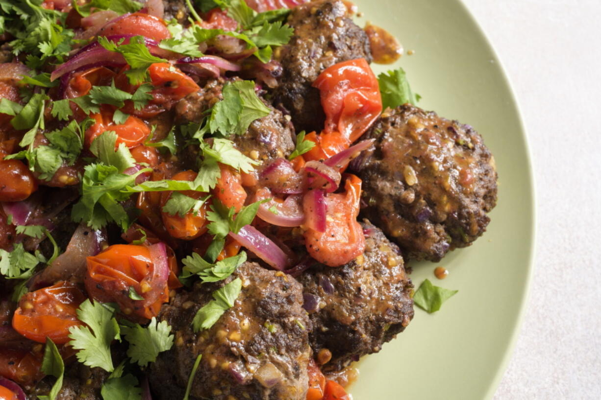 This image released by Milk Street shows a recipe for Spicy Ground Beef Kebabs w/Tomato-Sumac Sauce.