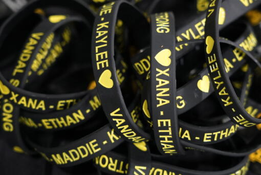 Bracelets with the names of the four University of Idaho students who were killed on Nov. 13, 2022, are displayed on a table at a vigil for the victims, Wednesday, Nov. 30, 2022, in Moscow, Idaho. (AP Photo/Ted S.