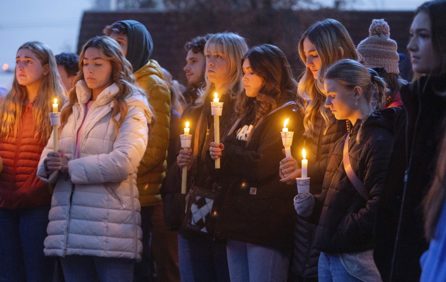 FILE - Boise State University students, along with people who knew the four University of Idaho students who were found killed in Moscow, Idaho, days earlier, pay their respects at a vigil held in front of a statue on the Boise State campus, Thursday, Nov. 17, 2022, in Boise, Idaho. The arrest of Bryan Christopher Kohberger in the Nov. 13, 2022 fatal stabbings of four University of Idaho students has brought relief to the small college town of Moscow, Idaho.(Sarah A.