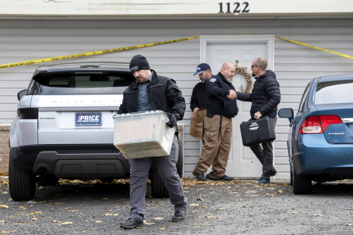 FILE - Officers investigate the deaths of four University of Idaho students at an apartment complex south of campus on Nov. 14, 2022, in Moscow, Idaho. It's been nearly three weeks since four University of Idaho students were found stabbed to death in a home near campus, but there are still more questions than answers surrounding the investigation.