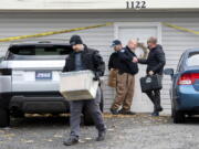 FILE - Officers investigate the deaths of four University of Idaho students at an apartment complex south of campus on Nov. 14, 2022, in Moscow, Idaho. It's been nearly three weeks since four University of Idaho students were found stabbed to death in a home near campus, but there are still more questions than answers surrounding the investigation.