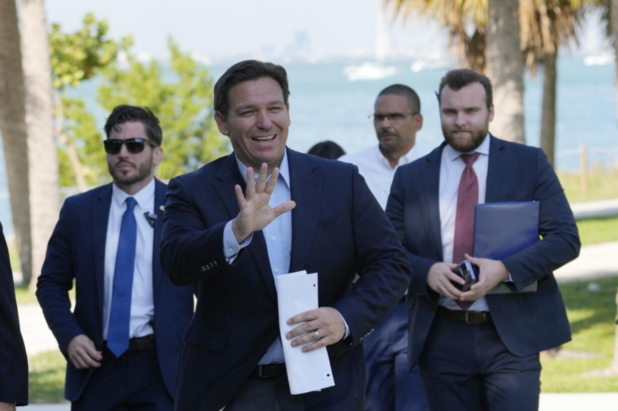 Florida Gov. Ron DeSantis waves as he arrives for a news conference at Bill Baggs Cape Florida State Park, Thursday, Dec. 1, 2022, on Key Biscayne, Fla. The Governor announced increased funding for the environmental protection of Biscayne Bay.