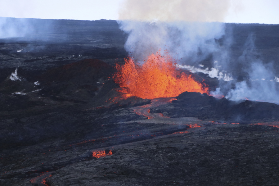This aerial image courtesy of Hawaii Dept. of Land and Natural Resources shows lava flows on Mauna Loa, the world's largest active volcano, on Wednesday, Nov. 30, 2022, near Hilo, Hawaii. (Hawaii Dept.
