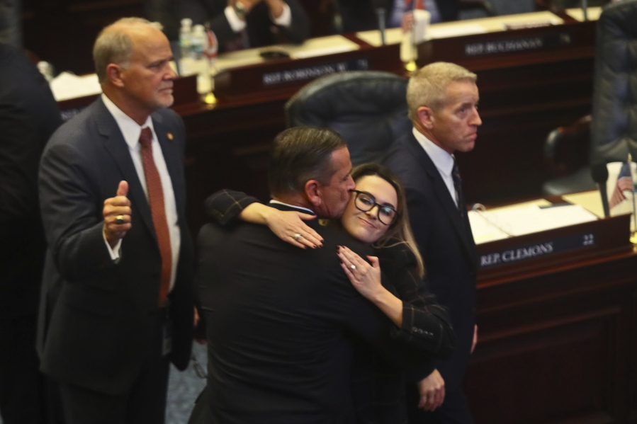 At center, Rep. Bob Rommel, R-Naples kisses Rep. Josie Tomkow, R-Polk City after his SB 2-A Property Insurance bill he co-sponsored passed 84-33 Wednesday, Dec. 14, 2022 in the House of Representatives in Tallahassee, Fla. At left is Rep. Bobby Payne, R-Palatka; at right is House Speaker Paul Renner, R-Palm Coast. Florida lawmakers are meeting to consider ways to shore up the state's struggling home insurance market in the year's second special session devoted to the topic.