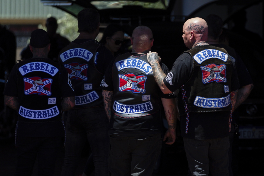 Mourners gather at a funeral parlor in north Perth, Australia before riding to the funeral of murdered Rebels biker Nick Martin at Pinnaroo Cemetery in Perth, Australia, on Wednesday, Dec. 23, 2020. The former Rebels president was gunned down earlier in the month at the Perth Motorplex. Martin's murder left police a trove of evidence that led them to the culprit. But they wanted more. The coronavirus pandemic provided it in the form of an electronic dragnet: QR code check-in data from contact tracing apps of 2,439 fans who attended the December 2020 race.