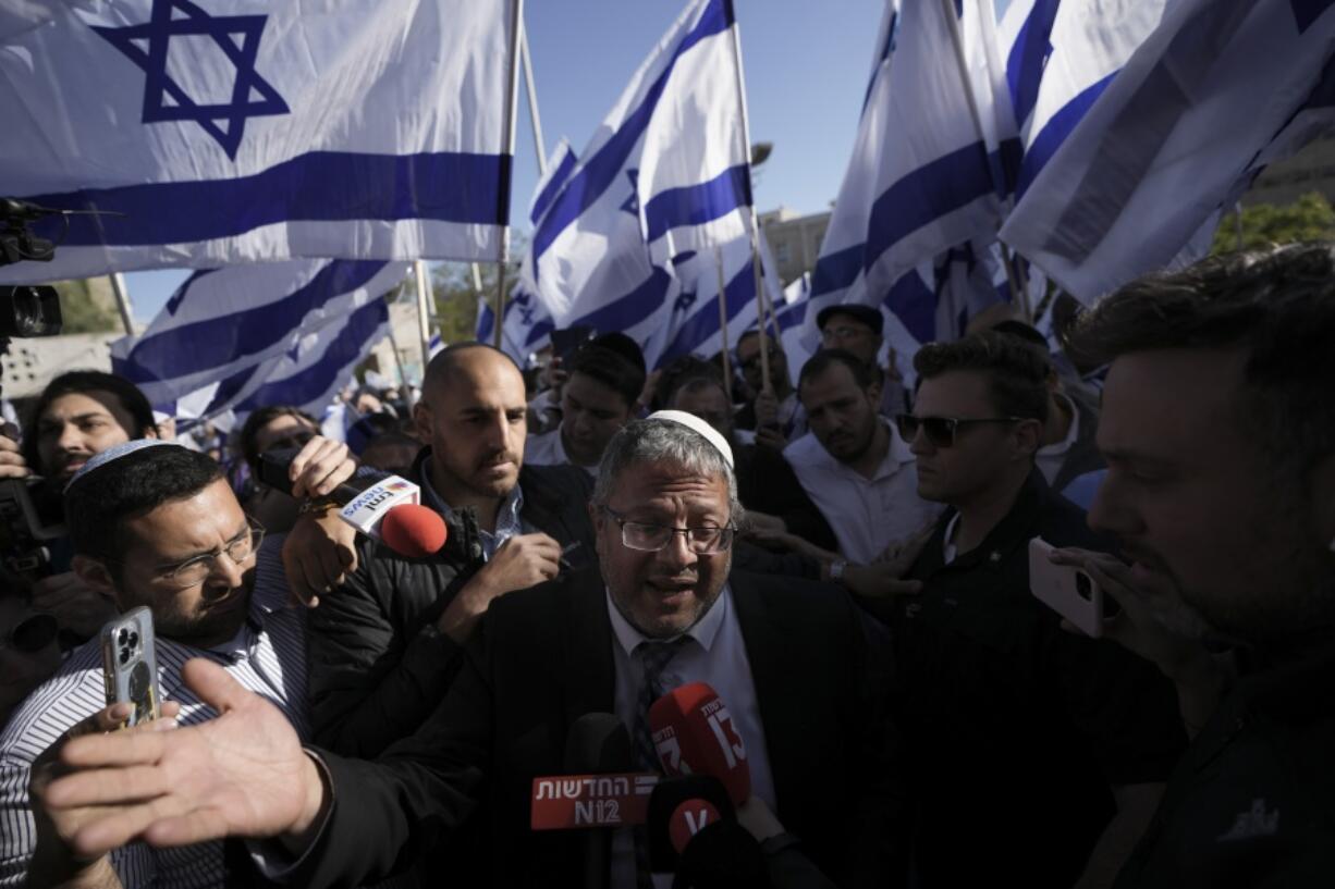 FILE - Israeli lawmaker Itamar Ben-Gvir, center, surrounded by right wing activists with Israeli flags, speaks to the media as they gather for a march in Jerusalem, Wednesday, April 20, 2022. Major Jewish American organizations, traditionally a bedrock of support for Israel, have expressed alarm over the presumptive government's far-right character. Given American Jews' predominantly liberal political views and affinity for the Democratic Party, these misgivings could have a ripple effect in Washington and further deepen what has become a partisan divide over support for Israel.