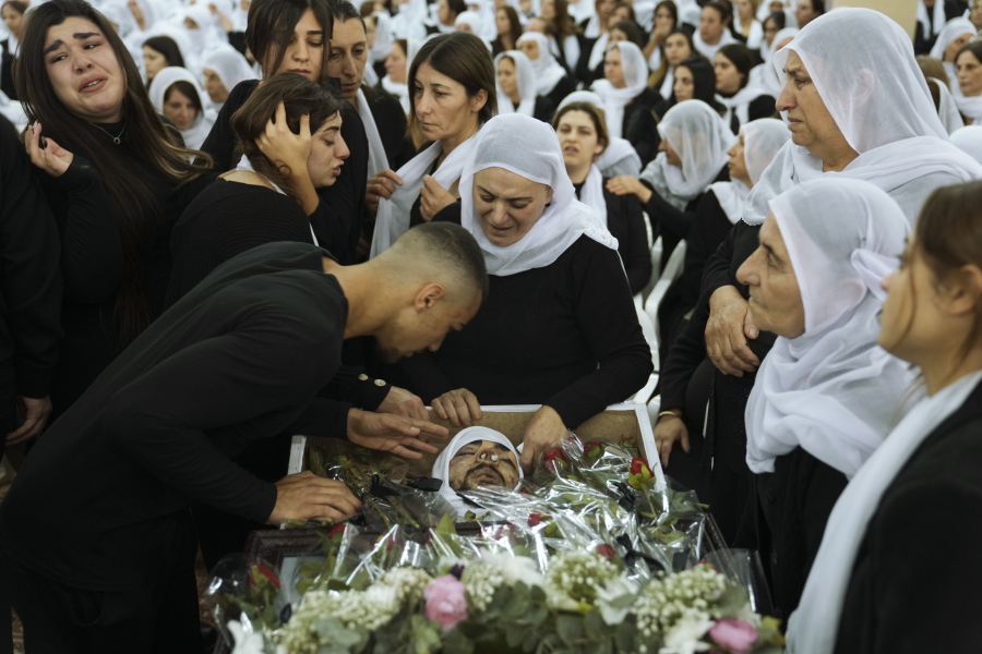 FILE - Members of the Israeli Druze minority mourn around the body of Tiran Fero, 17, during his funeral in Daliyat al-Carmel, Israel, on Nov. 24, 2022. Israel's military says its prosecutor has filed indictments against two soldiers who allegedly hurled an explosive device at a Palestinian home in the occupied West Bank last month. The indictment announced Thursday, Dec. 29,  said the two soldiers acted out of revenge for the kidnapping of the body of an Israeli schoolboy in the flashpoint West Bank city of Jenin on Nov. 22.