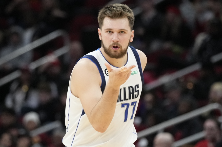 Dallas Mavericks guard Luka Doncic reacts after making a 3-point basket during the second half of an NBA basketball game against the Houston Rockets, Friday, Dec. 23, 2022, in Houston.