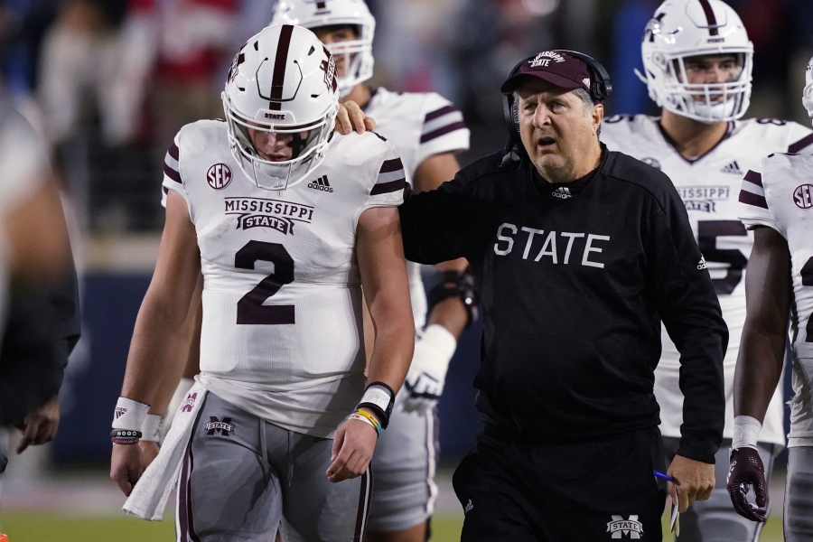 Mississippi State coach Mike Leach confers with quarterback Will Rogers (2) during the first half of the team's NCAA college football game against Mississippi in Oxford, Miss., Thursday, Nov. 24, 2022. (AP Photo/Rogelio V.