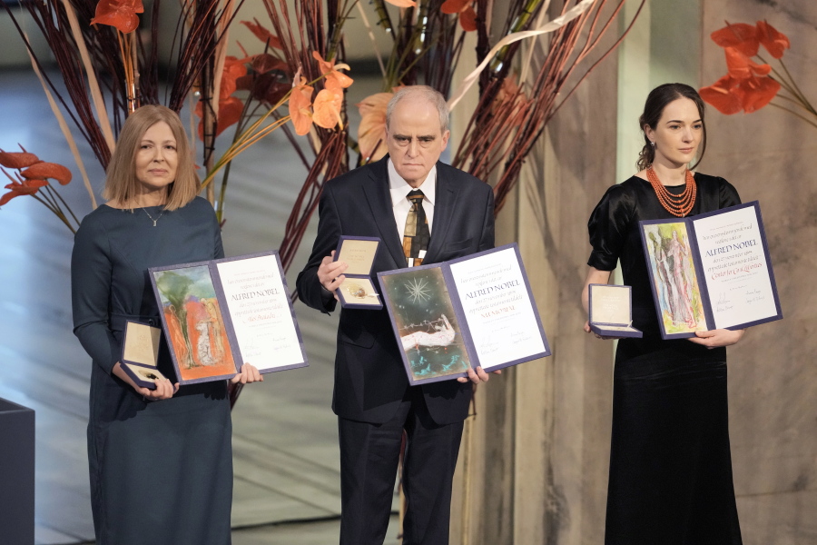 Representatives of the 2022 Nobel Peace Prize laureates, from left: Natalia Pinchuk, the wife of Nobel Peace Prize winner Ales Bialiatski, Yan Rachinsky, chairman of the International Memorial Board and Oleksandra Matviychuk, head of the Ukraine's Center for Civil Liberties pose with awards during the Nobel Peace Prize ceremony at Oslo City Hall, Norway, Saturday, Dec. 10, 2022. This year's Nobel Peace Prize was shared by jailed Belarus rights activist Ales Bialiatski, the Russian group Memorial and the Center for Civil Liberties in Ukraine. The Norwegian Nobel Committee said the laureates "have made an outstanding effort to document war crimes, human right abuses and the abuse of power.