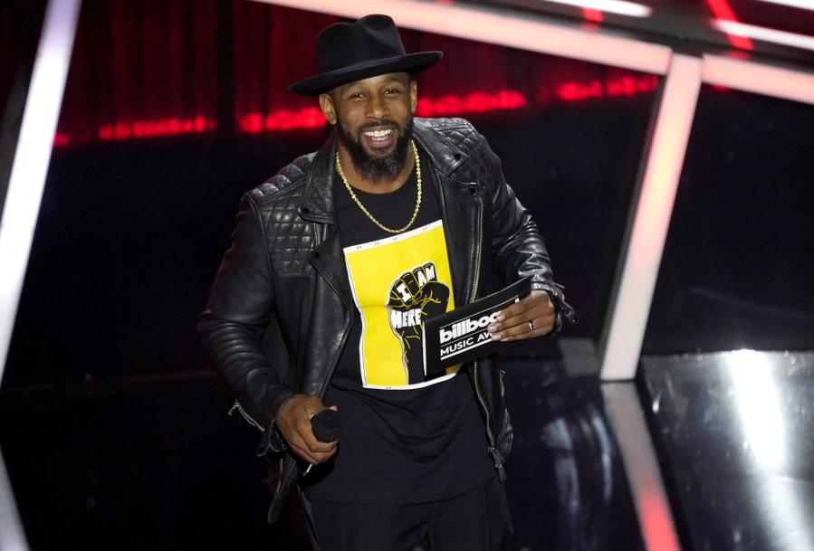 FILE - Stephen "tWitch" Boss presents the award for top Latin artist at the Billboard Music Awards in Los Angeles on Oct. 14, 2020.
