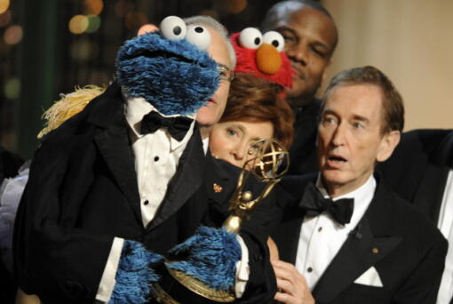 FILE - Bob McGrath, right, looks at the Cookie Monster as they accept the Lifetime Achievement Award for '"Sesame Street" at the Daytime Emmy Awards on Aug. 30, 2009, in Los Angeles. McGrath, an actor, musician and children's author widely known for his portrayal of one of the first regular characters on the children's show "Sesame Street" has died at the age of 90.  McGrath's passing was confirmed by his family who posted on his Facebook page on Sunday, Dec. 4, 2022.
