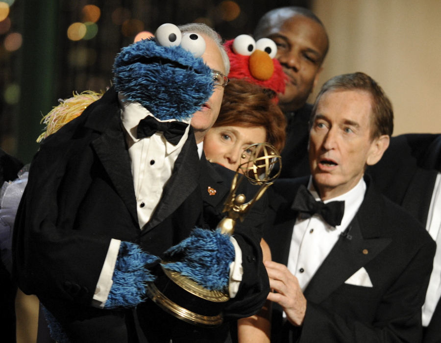 FILE - Bob McGrath, right, looks at the Cookie Monster as they accept the Lifetime Achievement Award for '"Sesame Street" at the Daytime Emmy Awards on Aug. 30, 2009, in Los Angeles. McGrath, an actor, musician and children's author widely known for his portrayal of one of the first regular characters on the children's show "Sesame Street" has died at the age of 90.  McGrath's passing was confirmed by his family who posted on his Facebook page on Sunday, Dec. 4, 2022.