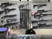 FILE - Firearms are displayed at a gun shop in Salem, Ore., on Feb. 19, 2021. Voters in Oregon passed one of the nation's strictest gun control laws, but the new permit-to-purchase mandate is facing a legal challenge with days to go before it takes effect. A federal judge in Portland will hear oral arguments Friday, Dec. 2, 2022, on whether Measure 114, which is scheduled to go into law Dec. 8, violates Americans' constitutionally protected right to bear arms.