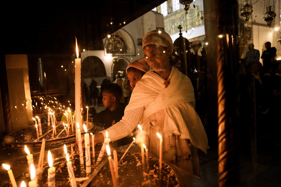 An Ethiopian woman and her child visit the Church of the Nativity, traditionally believed to be the birthplace of Jesus Christ, in the West Bank town of Bethlehem, Saturday, Dec. 3, 2022. Business in Bethlehem is looking up this Christmas as the traditional birthplace of Jesus recovers from a two-year downturn during the coronavirus pandemic. Streets are already bustling with visitors, stores and hotels are fully booked and a recent jump in Israeli-Palestinian fighting appears to be having little effect on the vital tourism industry.