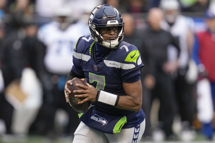 Seattle Seahawks quarterback Geno Smith (7) moves in the pocket against the Carolina Panthers during the first half of an NFL football game, Sunday, Dec. 11, 2022, in Seattle.