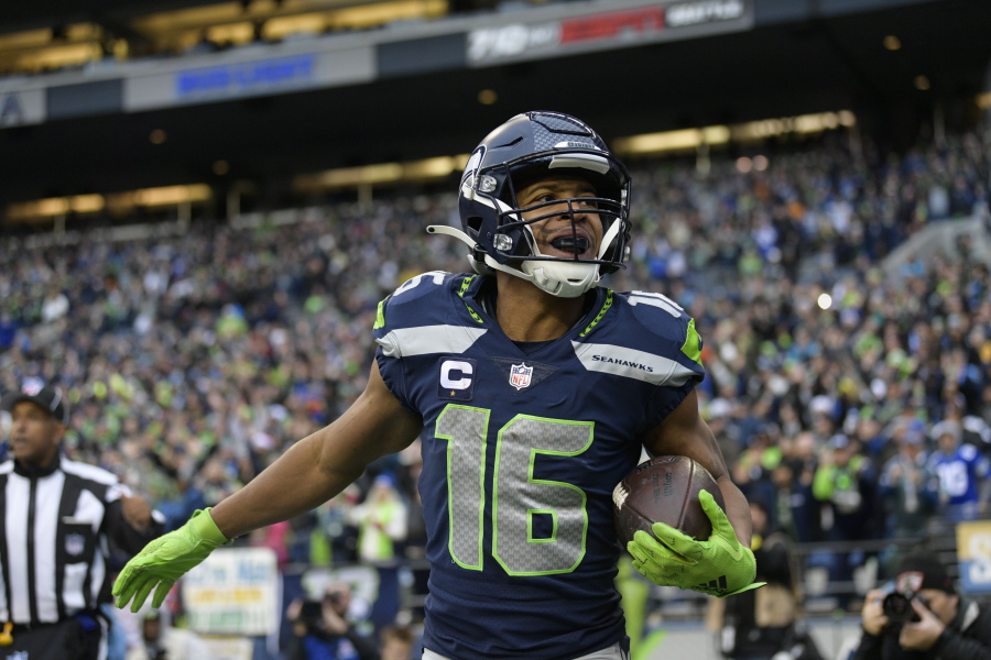 Seattle Seahawks wide receiver Tyler Lockett (16) celebrates his touchdown against the Carolina Panthers during the first half of an NFL football game, Sunday, Dec. 11, 2022, in Seattle.