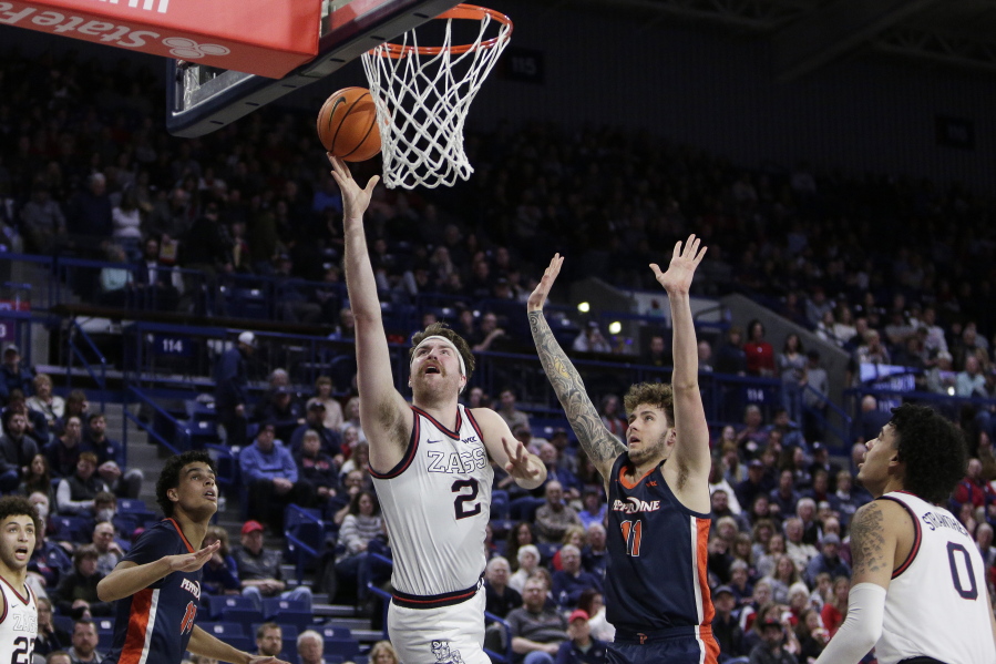 Gonzaga forward Drew Timme (2) shoots while defended by Pepperdine center Carson Basham (11) during the second half of an NCAA college basketball game, Saturday, Dec. 31, 2022, in Spokane, Wash.