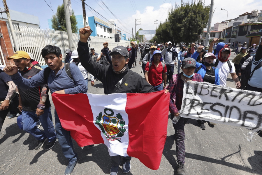 Supporters of ousted Peruvian President Pedro Castillo protest his detention in Arequipa, Peru, Wednesday, Dec. 14, 2022. Castillo was detained on Dec. 7 after he was ousted by lawmakers when he sought to dissolve Congress ahead of an impeachment vote.