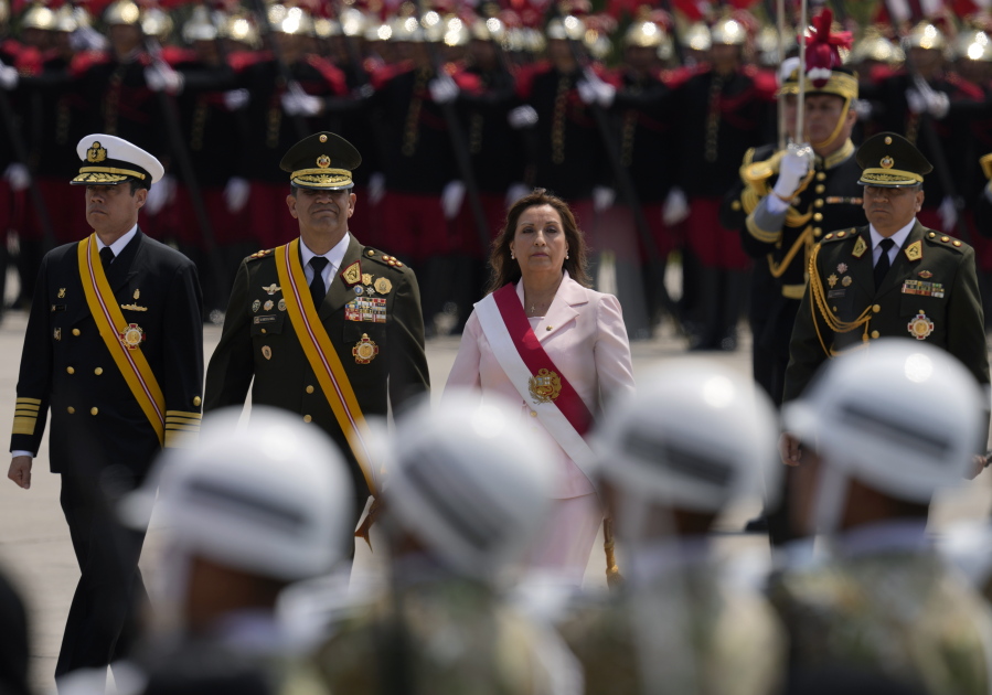 Peru's new President Dina Boluarte attends a ceremony marking Amy Day in Lima, Peru, Friday, Dec. 9, 2022. Peru's Congress voted to remove President Pedro Castillo from office Wednesday and replace him with the vice president, Boluarte, shortly after Castillo tried to dissolve the legislature ahead of a scheduled vote to remove him.