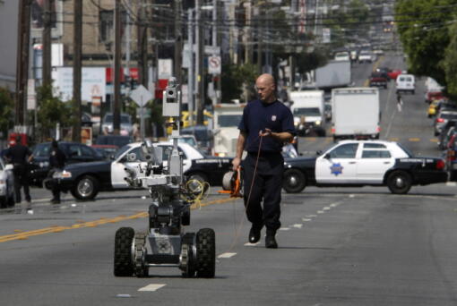 A police officer uses a robot to investigate a bomb threat in San Francisco, on July 25, 2008. The liberal city of San Francisco became the unlikely proponent of weaponized police robots on Tuesday, Nov. 29, 2022, after supervisors approved limited use of the remote-controlled devices, addressing head-on an evolving technology that has become more widely available even if it is rarely deployed to confront suspects.
