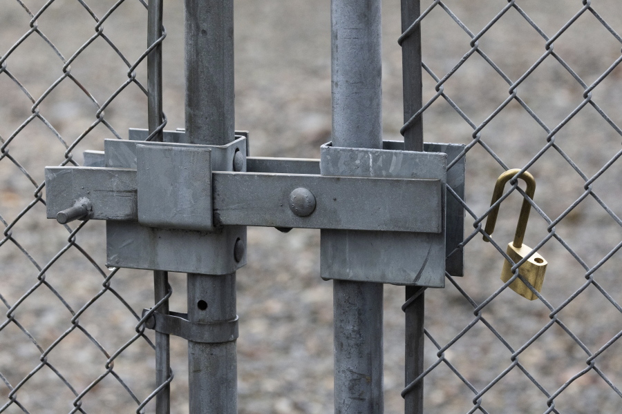 A Tacoma Power crew placed this new padlock at a substation gate after one that was cut off to break into the substation was taken away by law enforcement, Sunday, Dec. 25, 2022 in Graham, Wa.