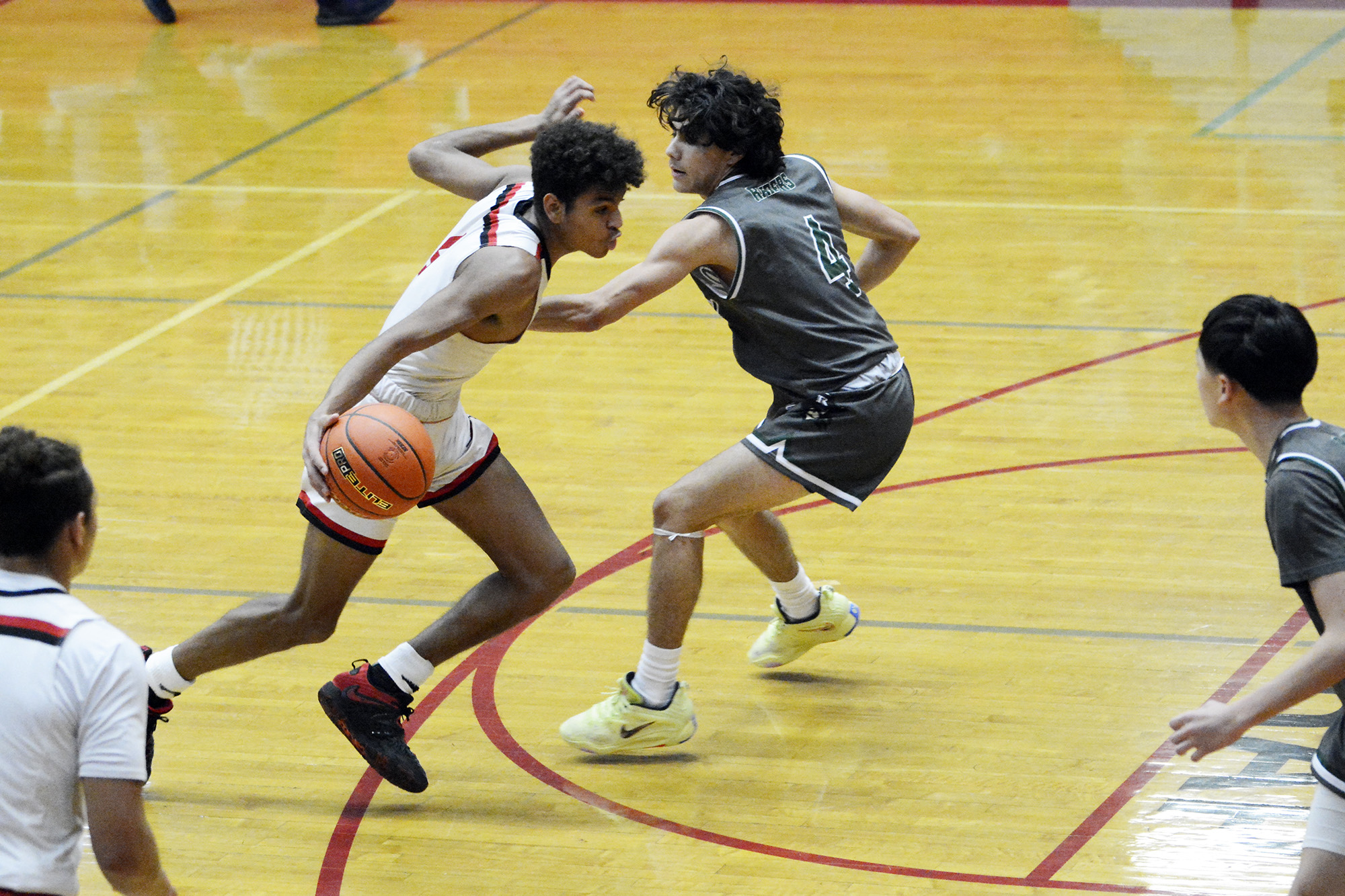 R.A. Long's Cavin Holden drives on Reynolds' Tyler Sanamane (4) at the Fort Vancouver Holiday Classic on Wednesday, Dec. 28, 2022.