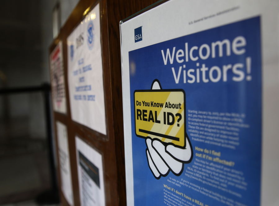 FILE - A sign at the federal courthouse in Tacoma, Wash., is shown on April 6, 2016, to inform visitors of the federal government's REAL ID Act, which requires state driver's licenses and ID cards to have security enhancements and be issued to people who can prove they are legally in the United States. The deadline for obtaining the Real ID needed to board a domestic flight has been pushed back again, with the Department of Homeland Security citing the lingering impact of the COVID-19 pandemic for the slower-than-expected rollout. (AP Photo/Ted S.