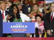 FILE - Former President Donald Trump, left, and Michigan Republican attorney general candidate Matt DePerno, right, listen as Michigan Republican secretary of state candidate Kristina Karamo addresses the crowd during a rally at the Macomb Community College Sports & Expo Center in Warren, Mich., Saturday, Oct. 1, 2022. Karamo, a community college instructor, ran as a far-right candidate in the 2022 midterms after becoming one of the most prominent election conspiracists in the country.