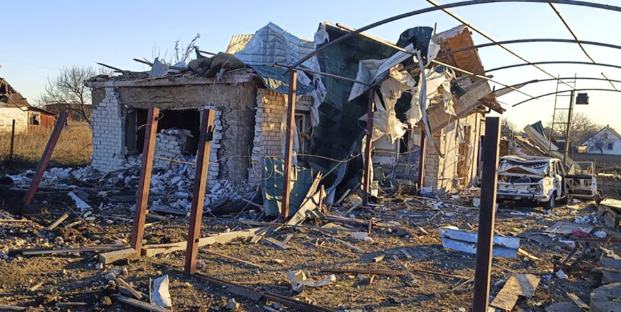 In this photo provided by the Zaporizhzhia region military administration, a damaged building and a car are seen after a Russian strike in the village of Novosofiivka, in the Zaporizhzhia region, Ukraine, Monday, Dec. 5, 2022. Ukrainian officials reported a new barrage of Russian missile strikes across the country Monday, an attack that was anticipated as Russia seeks to disable Ukraine's energy supplies and infrastructure with the approach of winter.