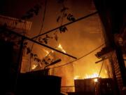 A house burns after a Russian attack in Kherson, Ukraine, Saturday, Dec. 3, 2022.